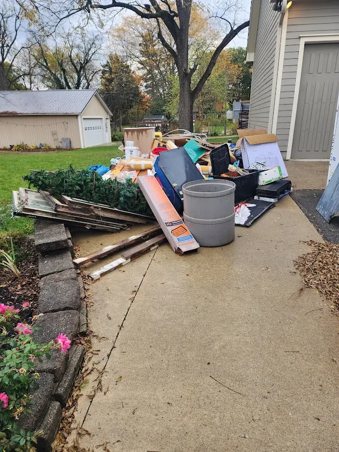 Dumpster being loaded with debris for Estate Cleanout Dumpster Rental in McHenry